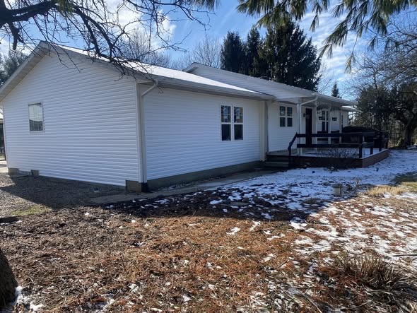 New white siding and gutters on a Shields Roofing and Siding project in Johnstown